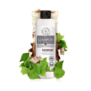 Pieniek brzozy oraz pięknie zielone liście stanowiące tło dla smukłej butelki zawierającej naturalny szampon do włosów